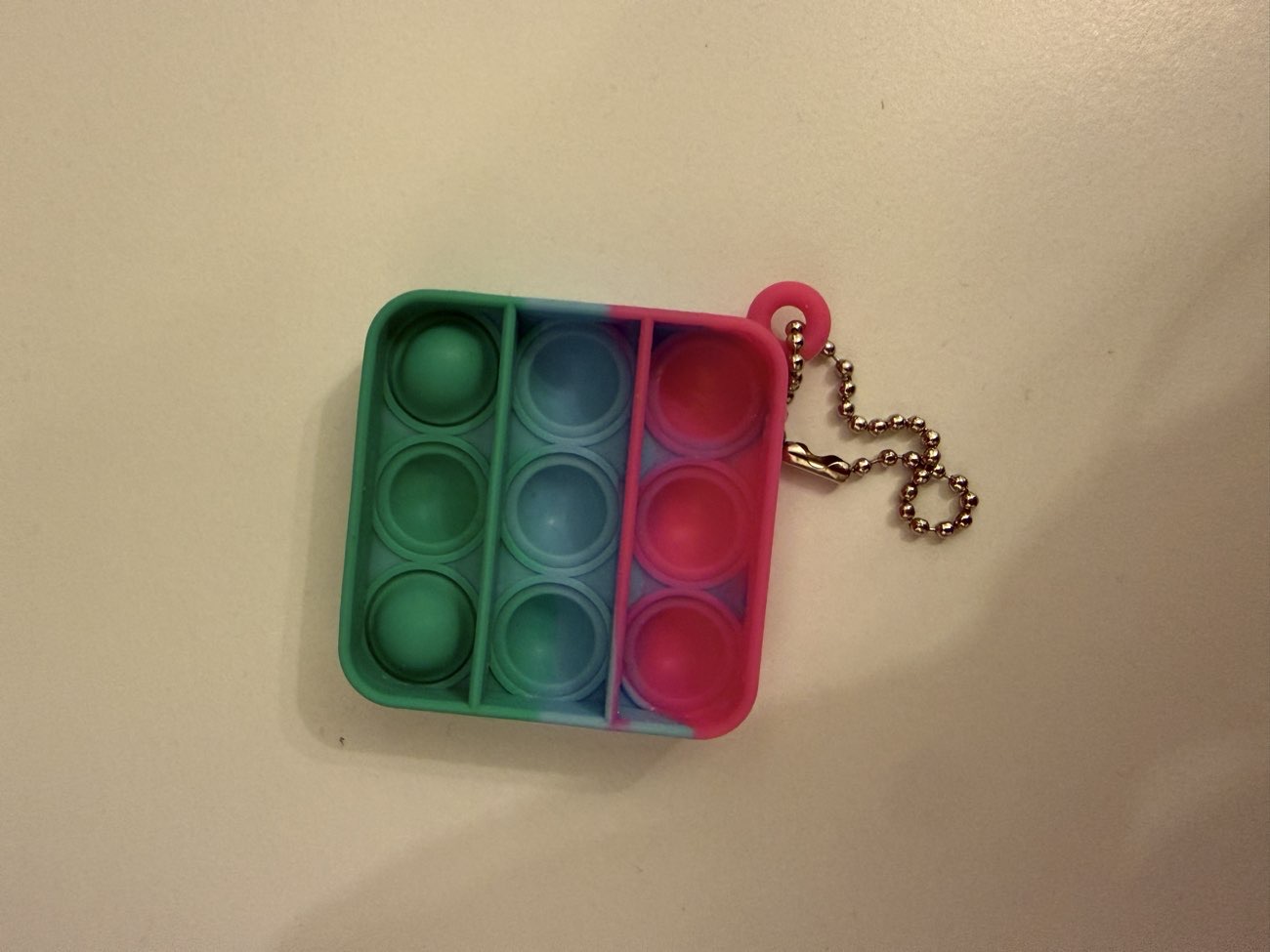 A colorful fidget keychain product bought at Peaceful Solutions for £1.00