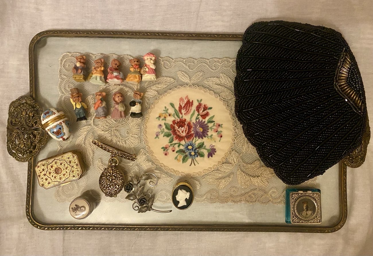 Trinkets, brooches, beaded shell bag, pillboxes, & vanity tray. They’ve a great range of things product bought at Vintage Dolly