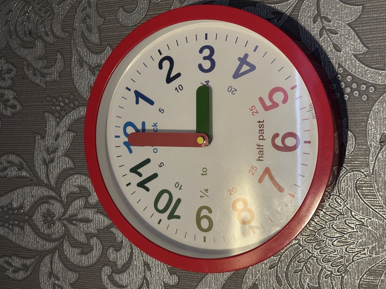 Wall clock 🕰️ for learning to tell the time; multicoloured & minutes in words bought at Down Syndrome Kerry Shop for €3.99