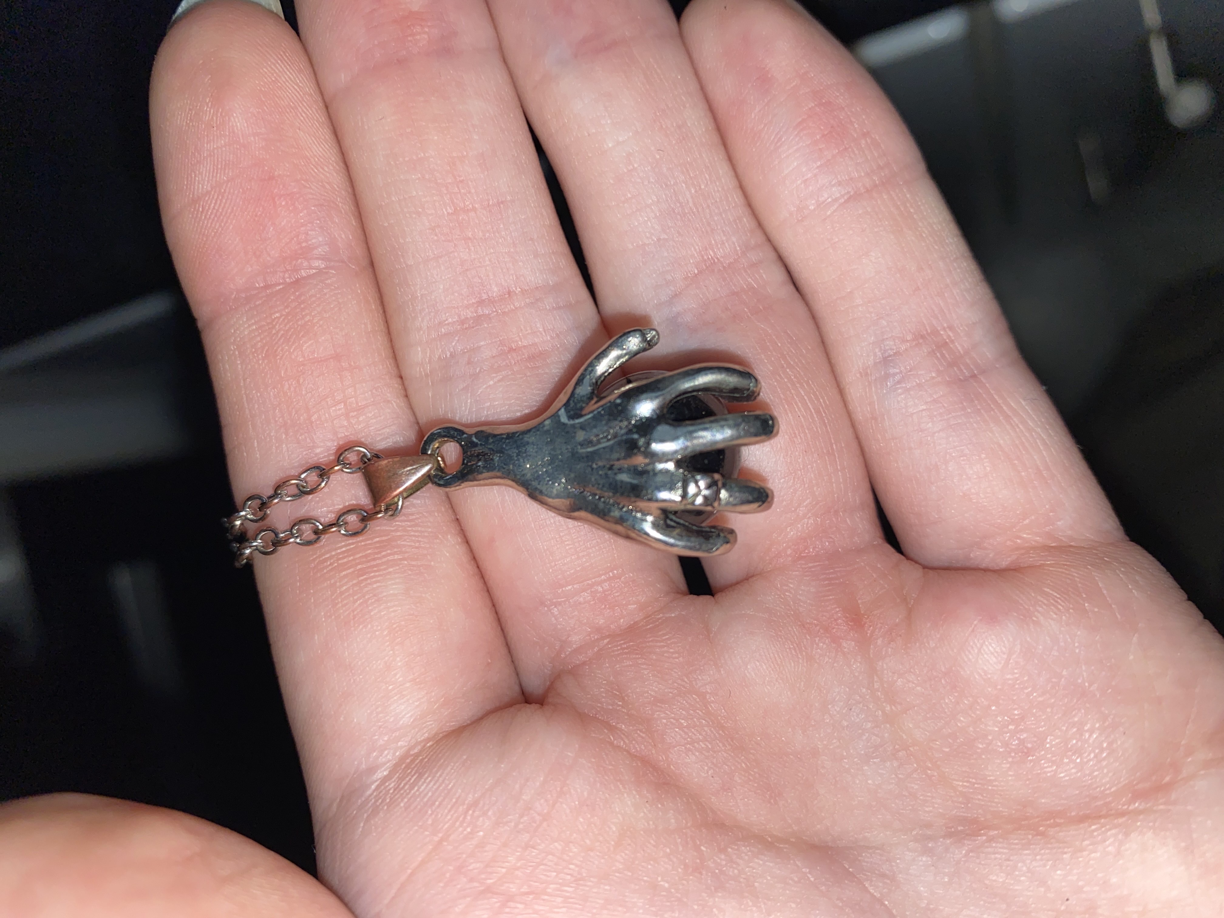 Really cool silver hand necklace, very detailed and holds a black orb. bought at Acton Recycling Community for £5.00