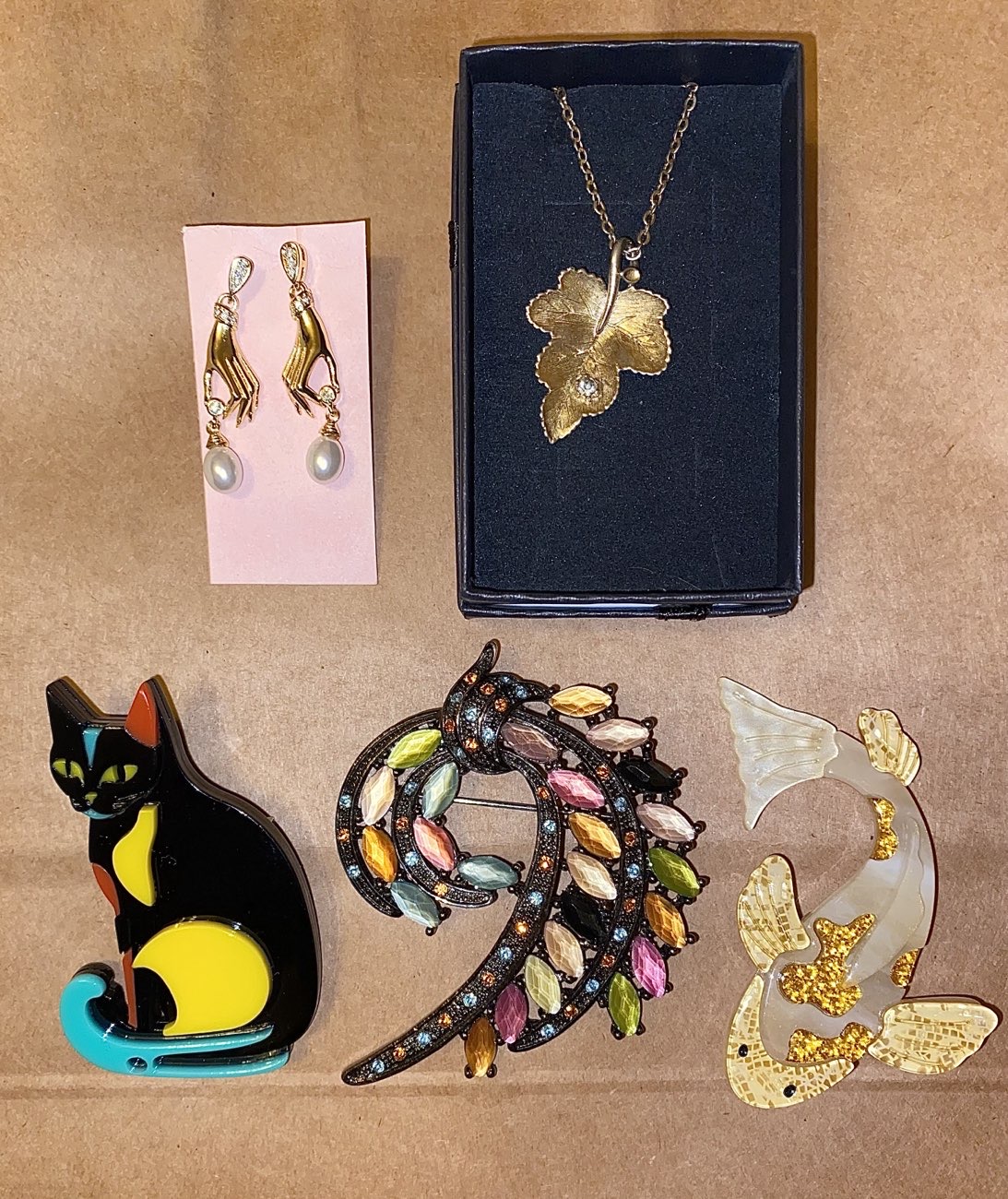 Hand earrings, vine leaf necklace, and 3 brooches. product bought at Vintage Dolly