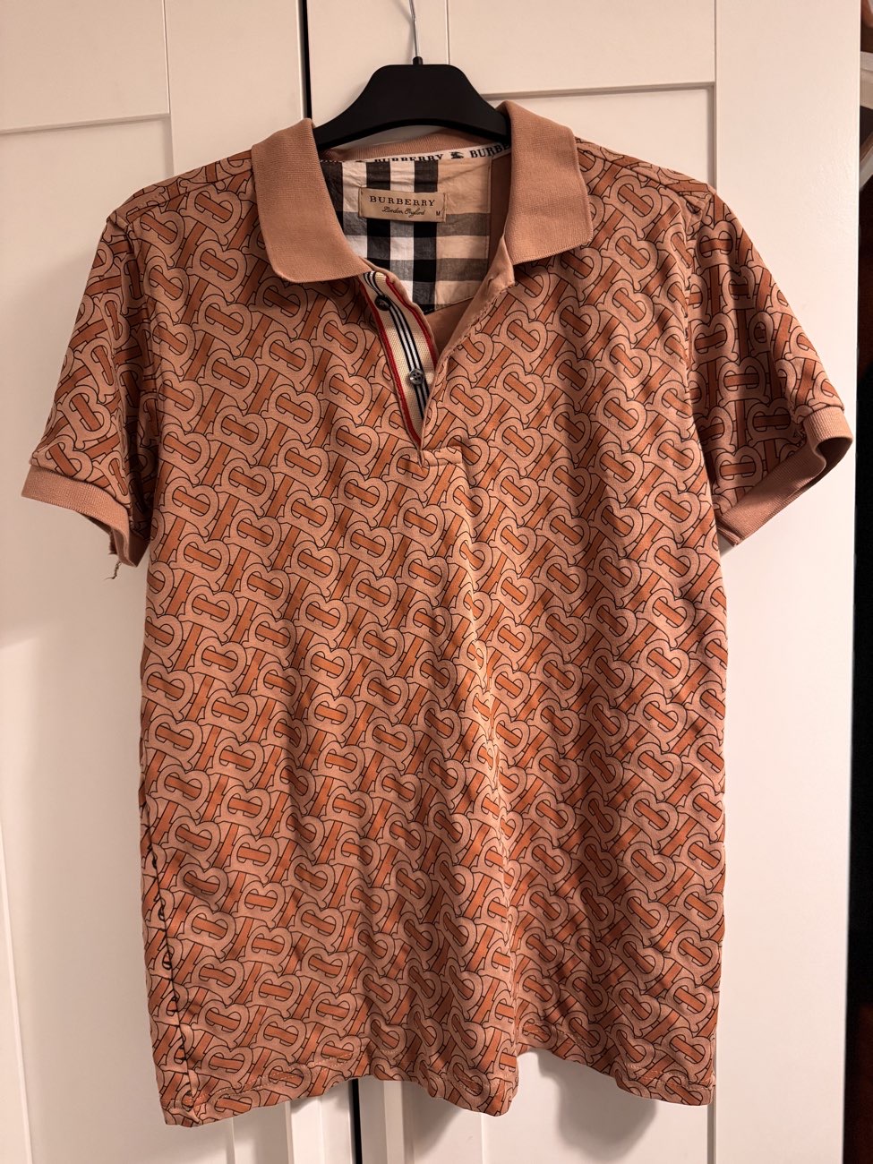 Burberry Polo shirt  ( obnoxiously printed , not my style, but couldn’t leave it behind,) product bought at Families Relief for £10.00