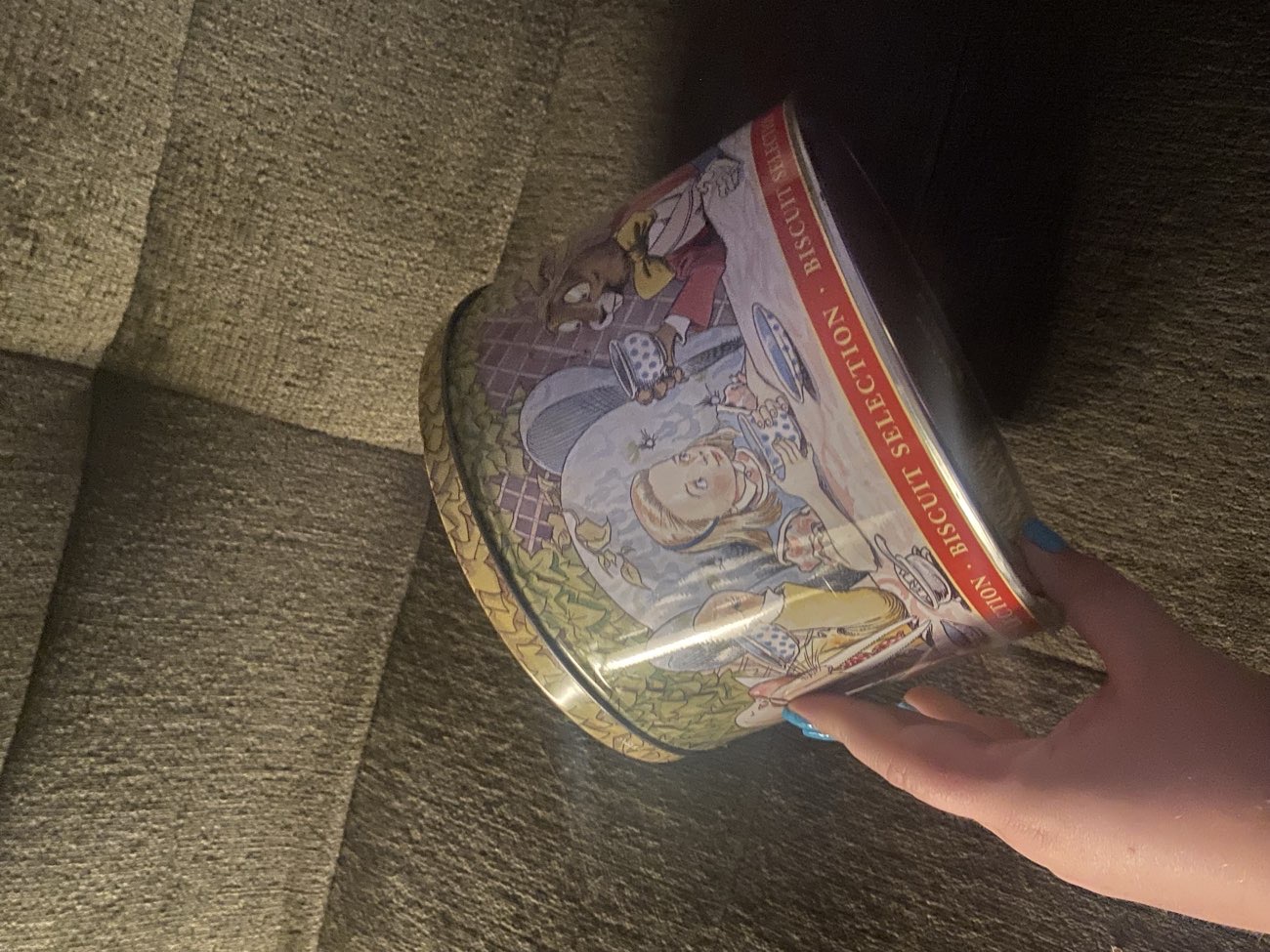 Alice in Wonderland biscuit tin (1991) bought at De-Part-Mental Store for Β£4.00