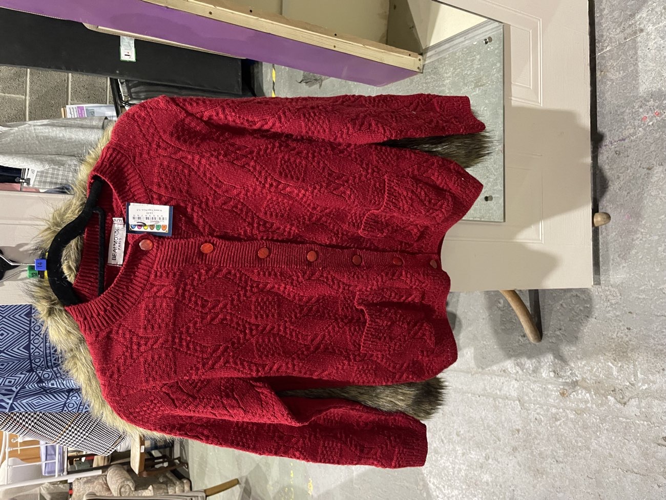 Red cardigan product bought at Xcel Community and Furniture Shop for £4.00