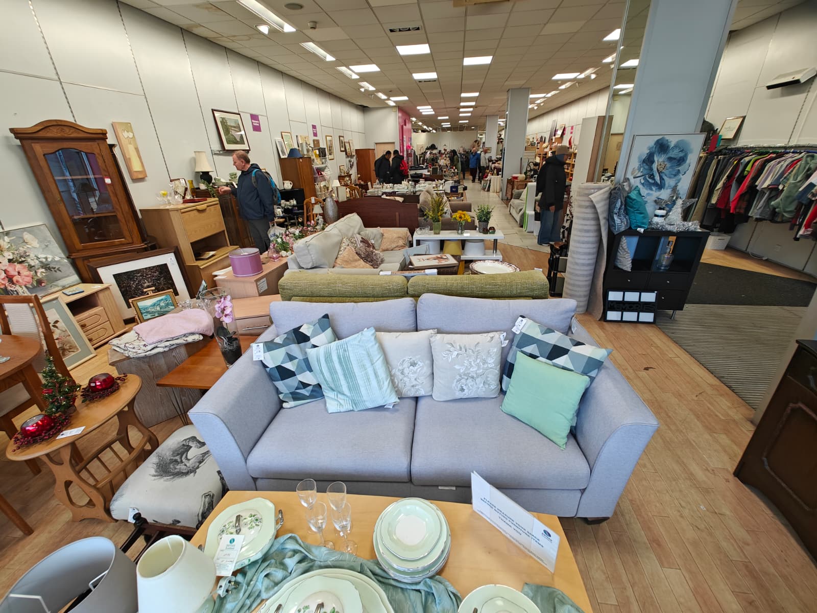 Interior of the Sense charity shop displaying a large selection of second-hand furniture and home decor