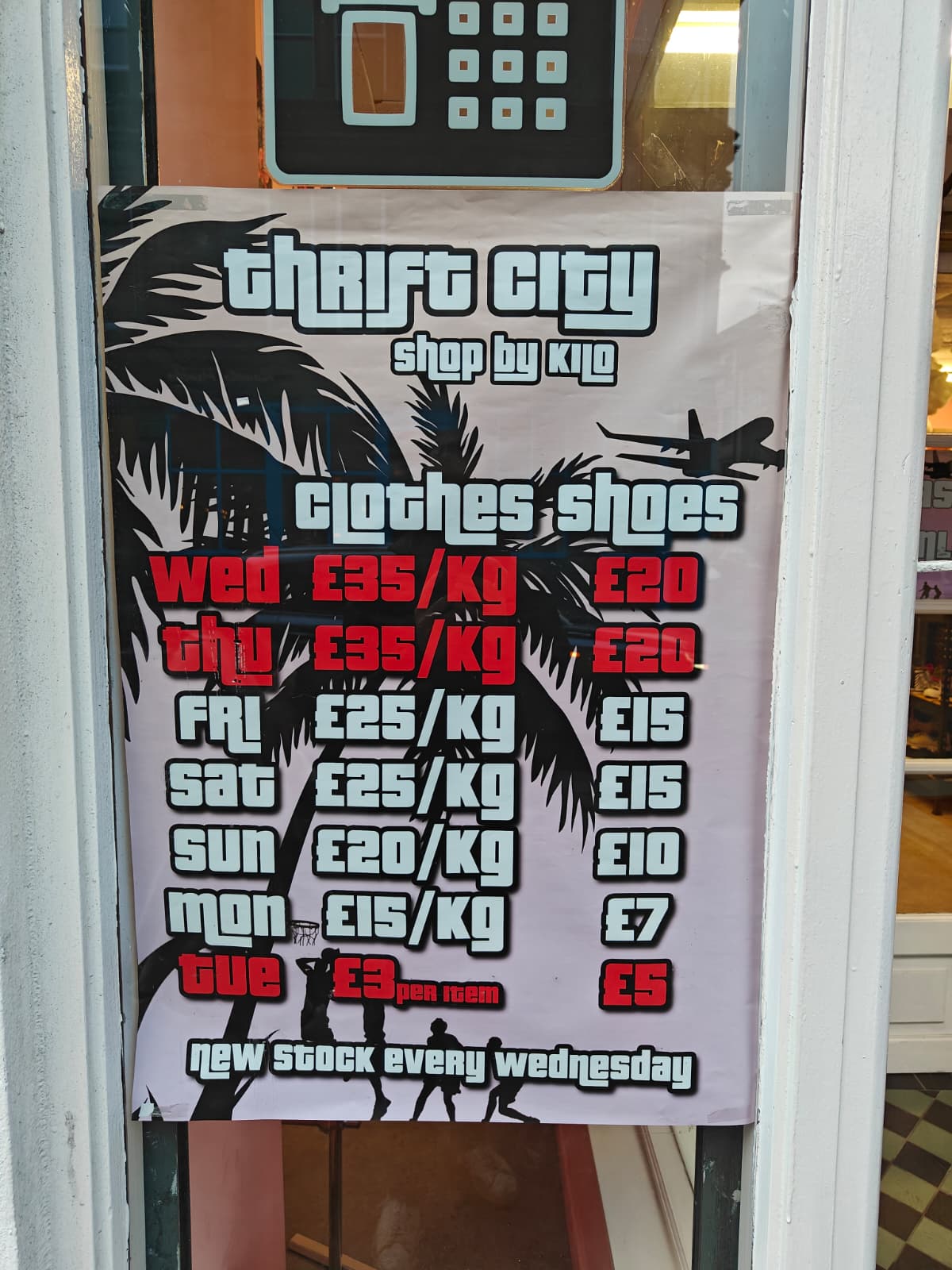 The by-the-kilo price list for Thrift City, a second-hand men's clothing shop in Dundee, Scotland (wed: £35/kg, thurs: 35/kg, fri £25/kg, sat: £25/kg, sun: £20/kg, mon: £15/kg, tues: £3/item)