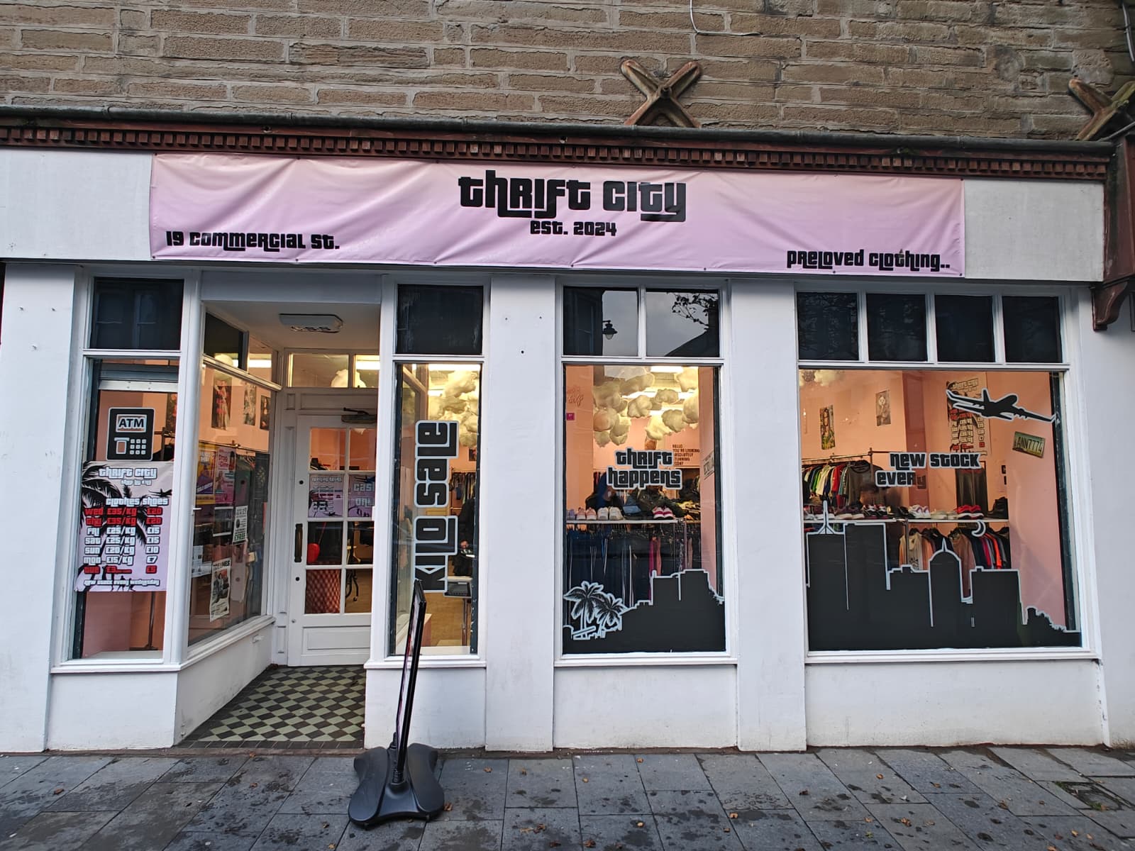 The storefront of Thrift City, a second-hand men's clothing shop in Dundee, Scotland