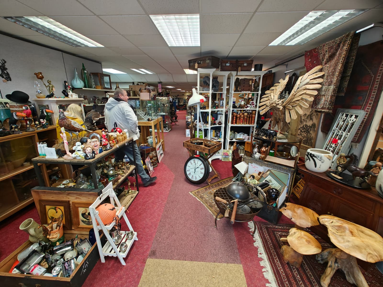 The interior of a large second-hand antiques shop in Blairgowrie, Scotland, packed with objects on shelves and on the floor