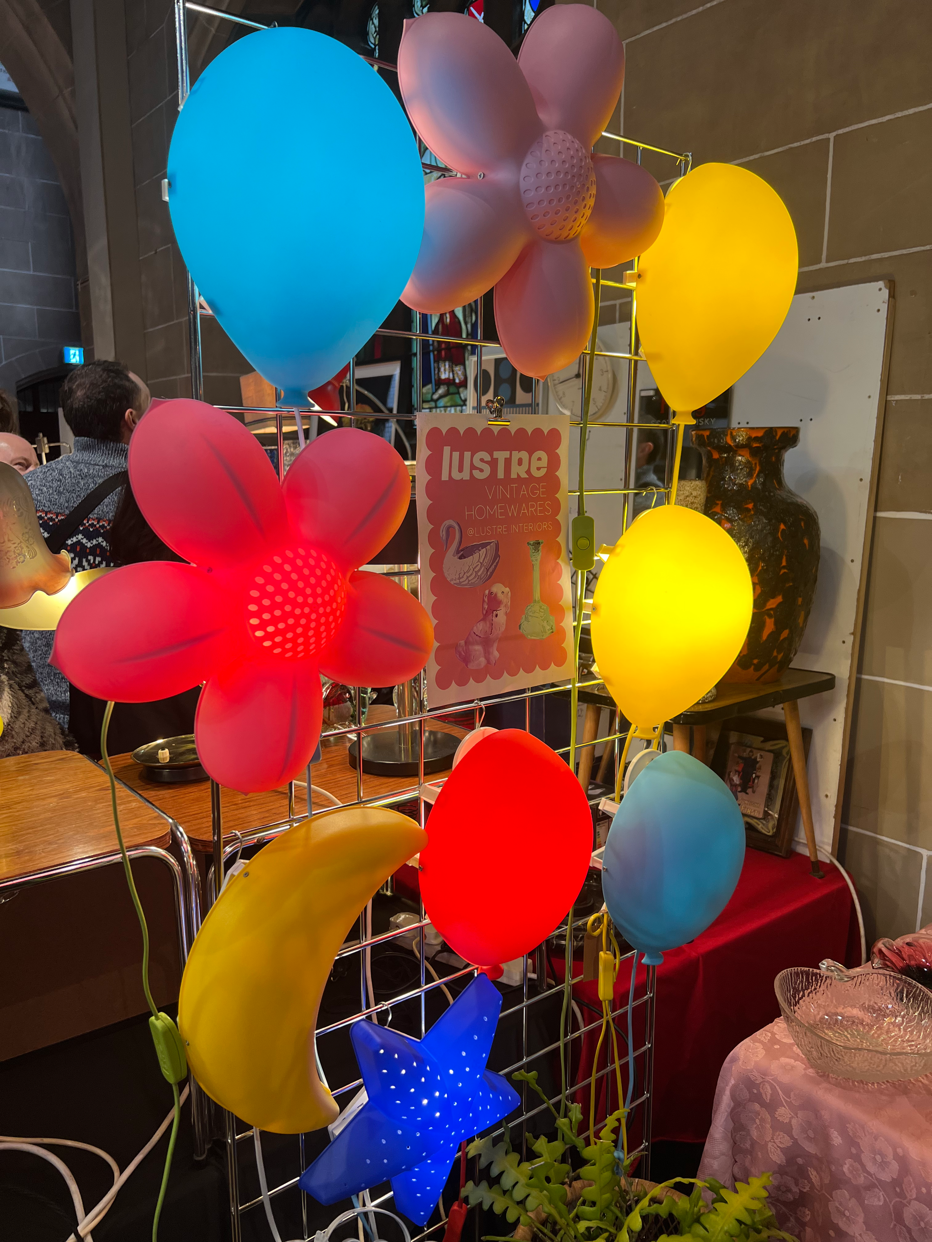 A wall full of colorful retro lights surrounding a vintage banner