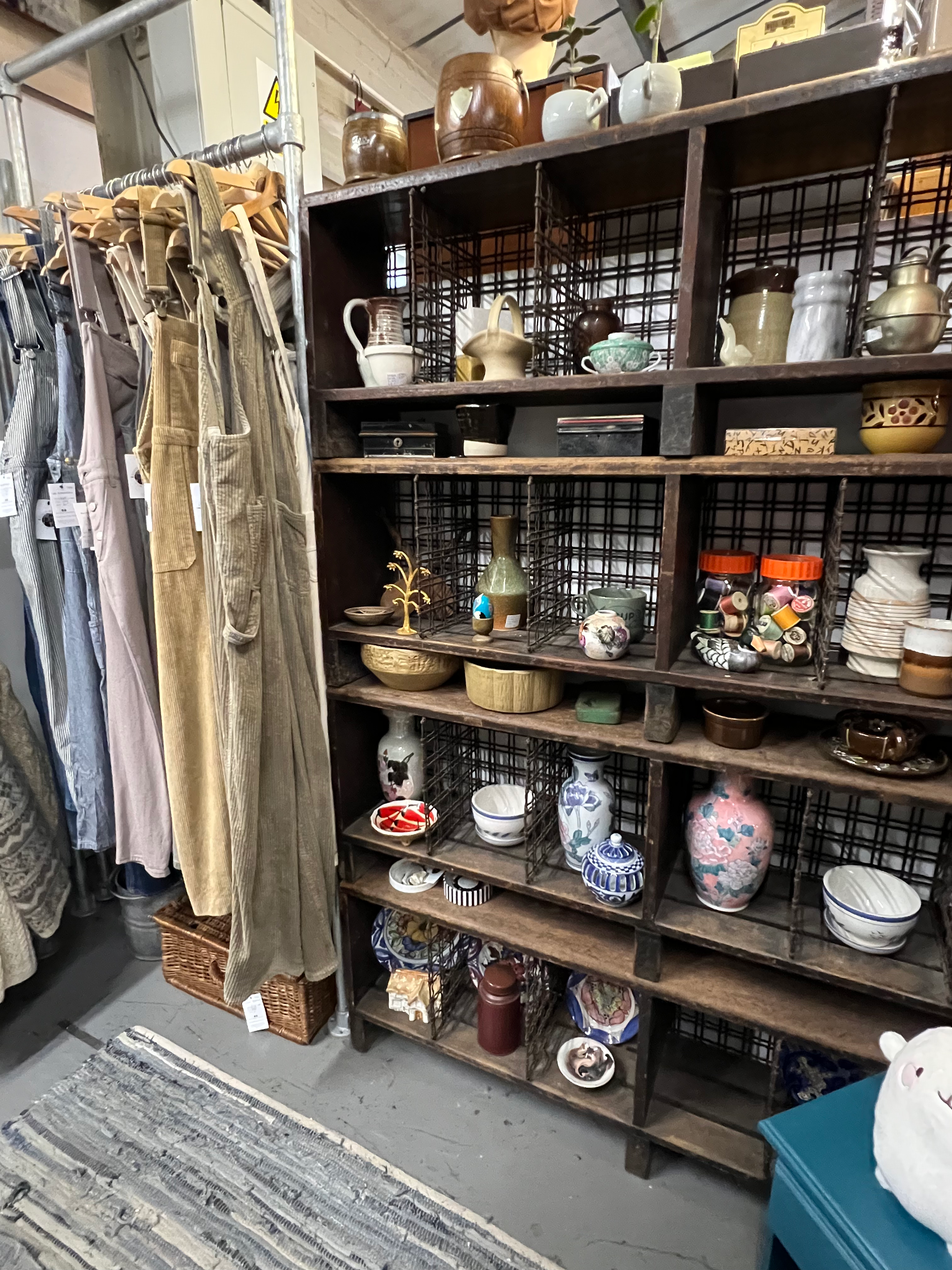 Corner of a second-hand shop with vintage clothing and vintage homeware and accessories