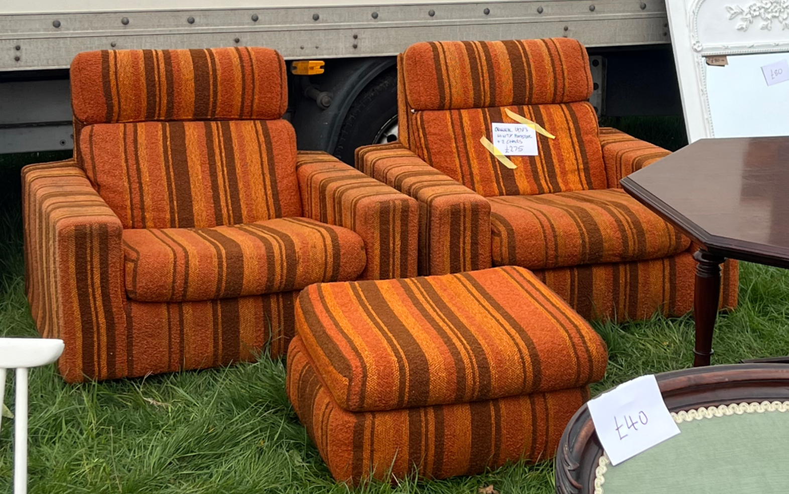Two vintage arm chairs and a foot stool in orange with stripes