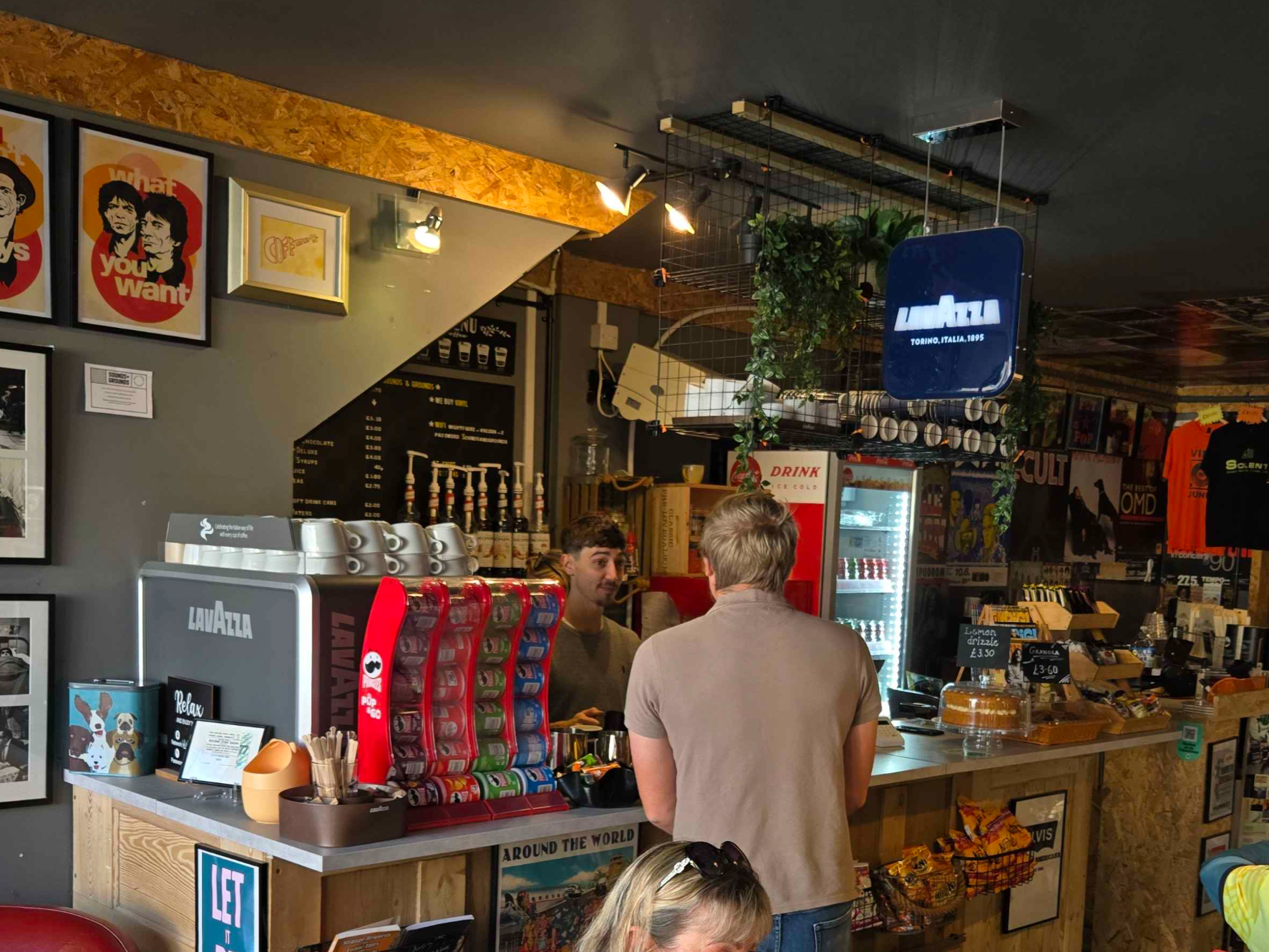 Sounds and Grounds's manager, Josh, serving customers at the cafe of the shop