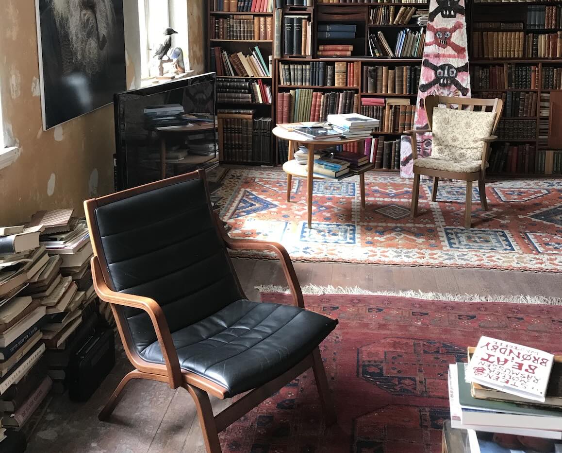 A beautiful vintage black leather chair in an old house's library