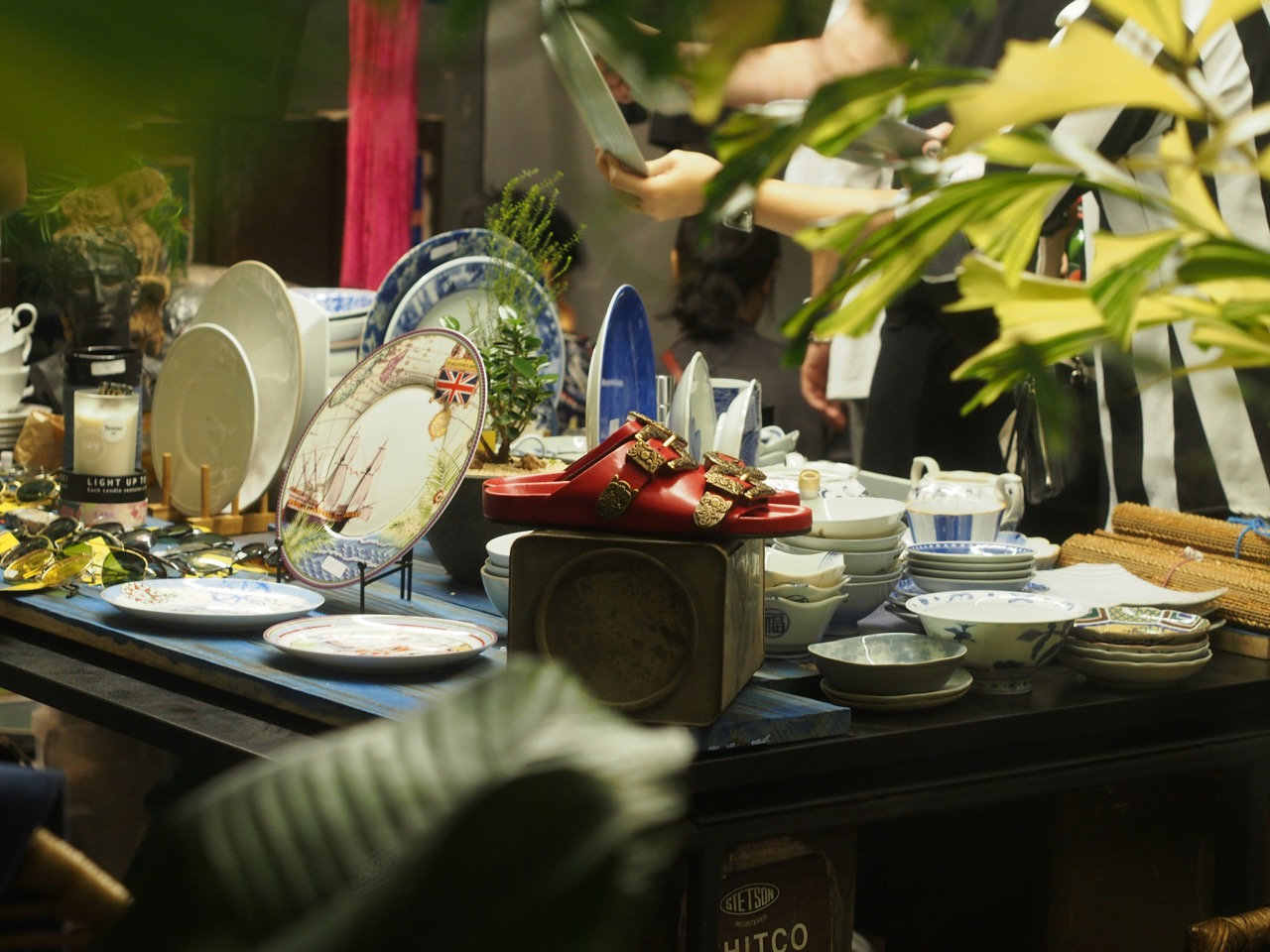 A close-up of a table sale with various knick-knacks, bric-a-brac, and more
