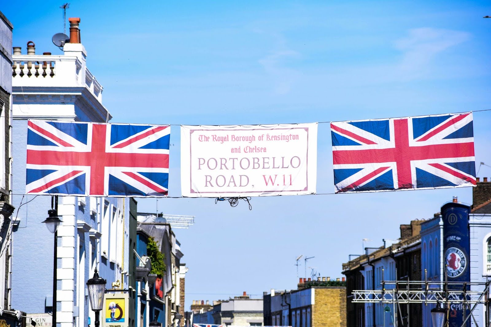 Portobello Road’s skyline and a banner containing the street name between two Union Jack flags.