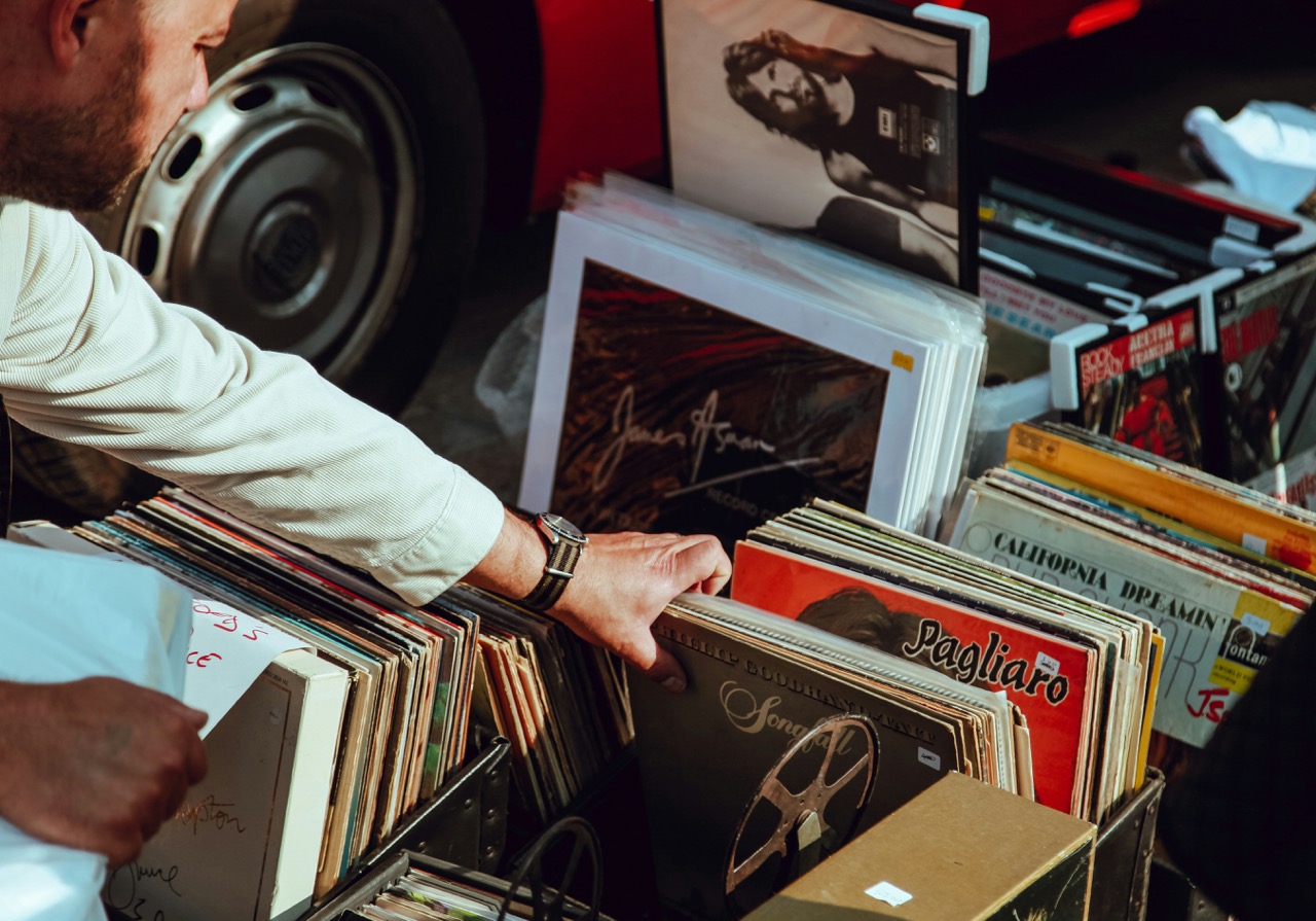 A guy sifting through boxes of old vintage vinyl records in a vintage store in London