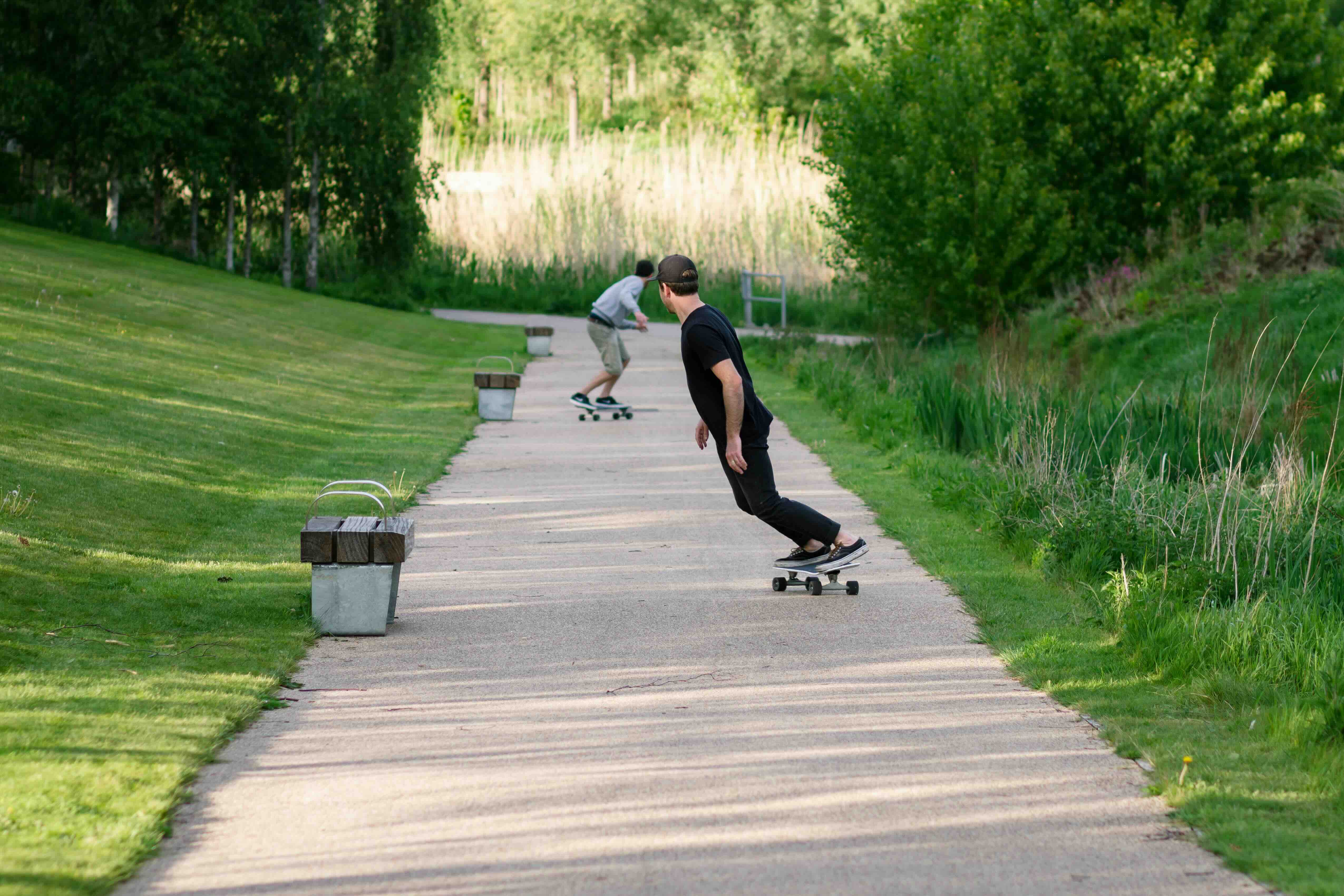 Two men skate boarding in Queen Elizabeth Park in the East part of London.