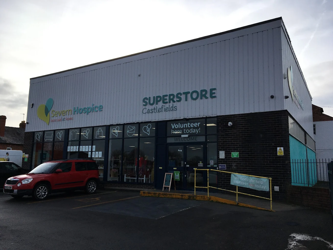 Exterior of Severn Hospice Superstore in Castlefields, a large charity shop with parking spaces in front.