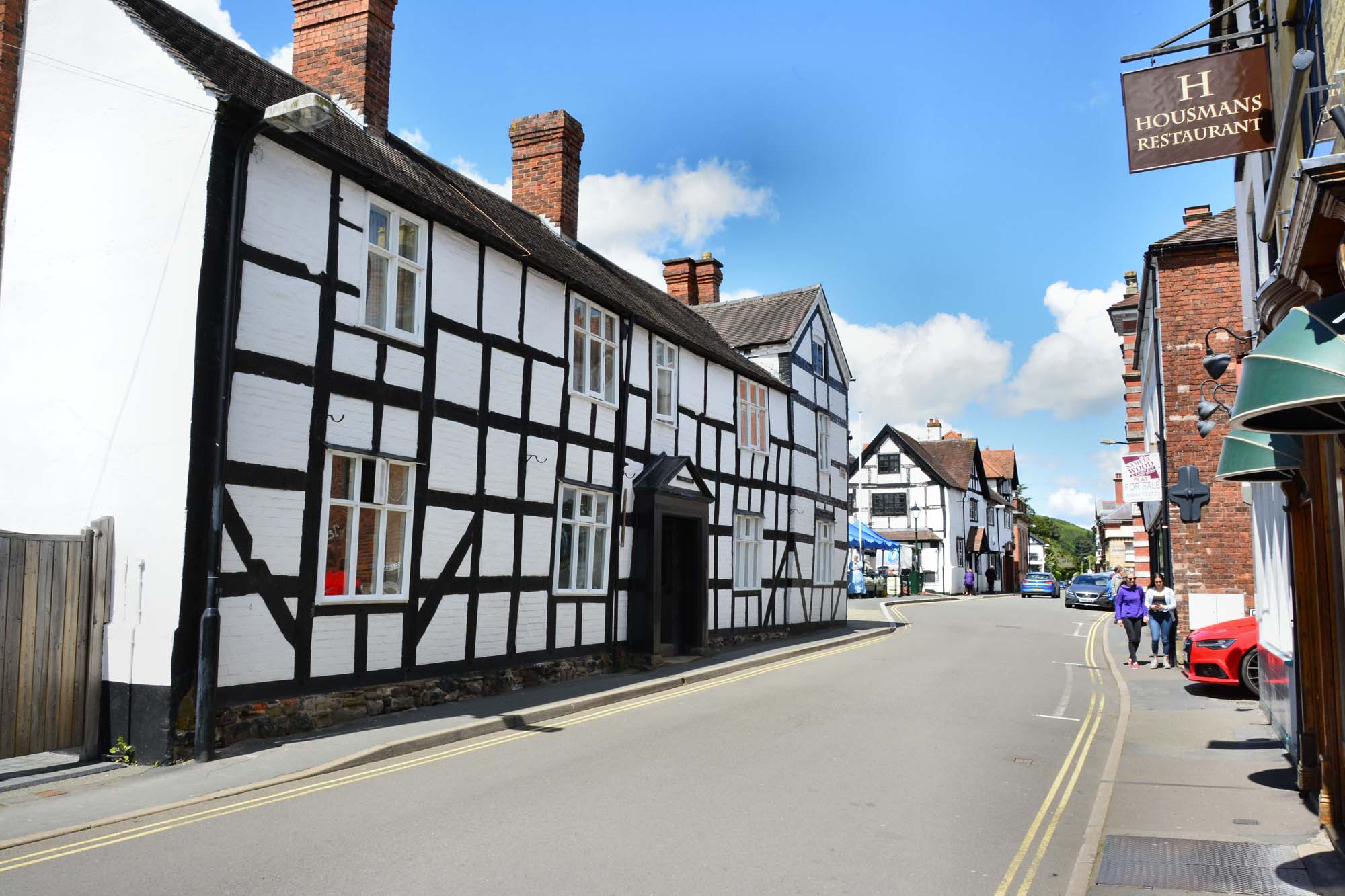 Street view of Church Stretton town centre in Shropshire, showing traditional black-and-white buildings and local shops