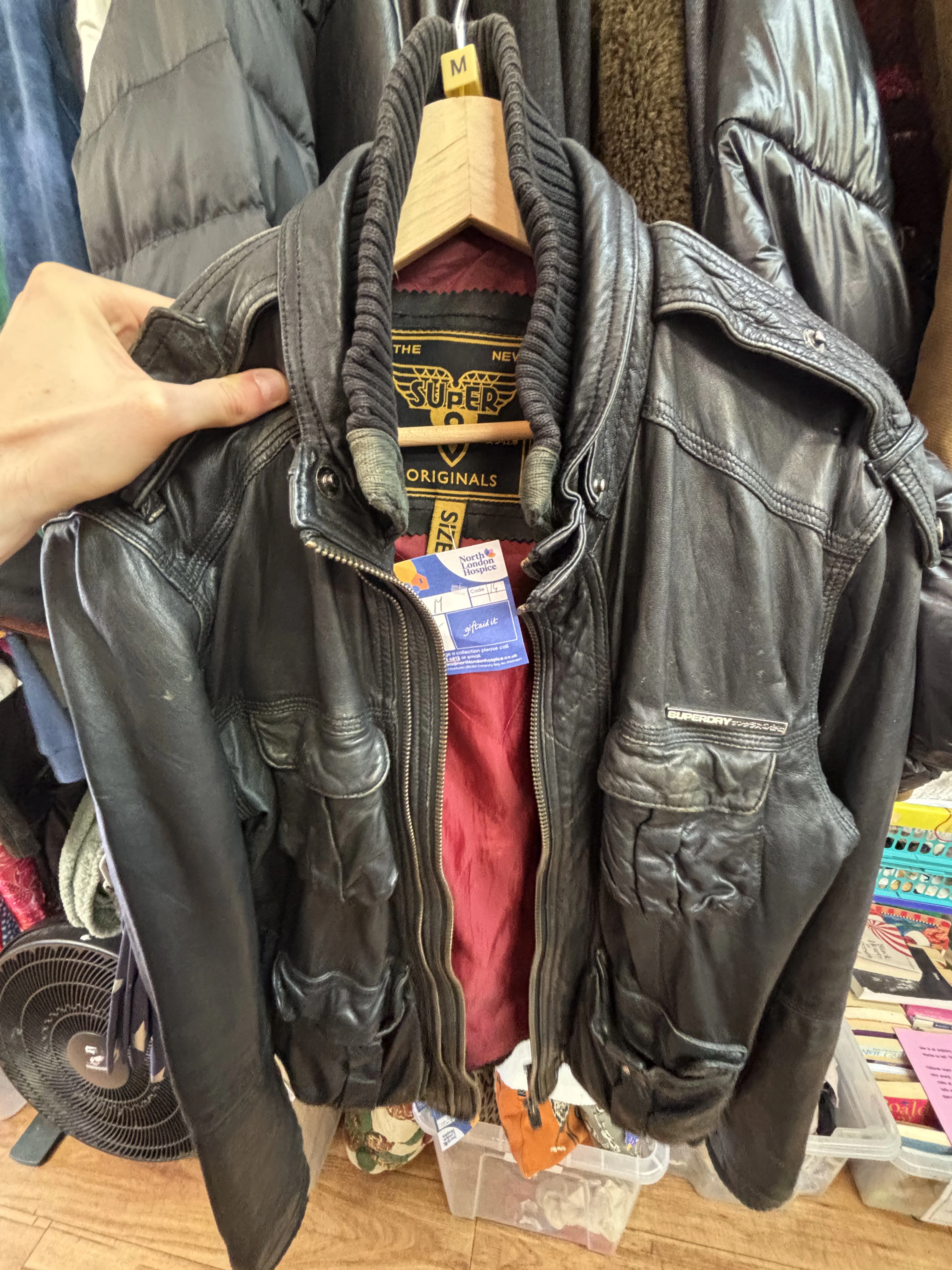 Black vintage leather jacket found inside a second-hand shop in London.